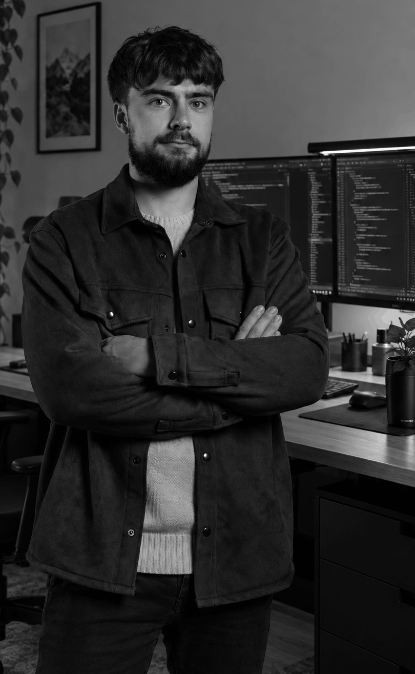 Cyril Salvi, arms crossed, in front of his development setup